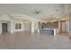 Spacious living room showcasing sleek tile floors, contemporary lighting, and an open layout into the kitchen area at 17756 E Colt Dr, Queen Creek, AZ 85142