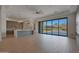 Open-concept living room featuring modern finishes, large windows, and an elegant transition to the kitchen area at 17756 E Colt Dr, Queen Creek, AZ 85142