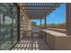 Covered patio with a built in BBQ and large sliding glass doors for indoor/outdoor living at 17756 E Colt Dr, Queen Creek, AZ 85142