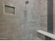 Detailed shower showcasing a mosaic accent stripe and a built-in bench at 17756 E Colt Dr, Queen Creek, AZ 85142