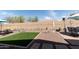 Beautifully landscaped backyard featuring decorative elements, artificial turf, gravel, and outdoor seating areas at 1844 E Angelica St, Casa Grande, AZ 85122