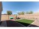 Well-maintained backyard offering a turf area, decorative gravel, garden beds, and a cozy seating arrangement at 1844 E Angelica St, Casa Grande, AZ 85122