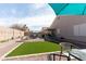 Expansive backyard with a manicured turf, multiple seating areas and a covered patio for outdoor relaxation at 1844 E Angelica St, Casa Grande, AZ 85122