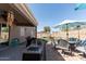 Inviting backyard featuring a covered patio, BBQ grill, outdoor seating, and a well-maintained landscape at 1844 E Angelica St, Casa Grande, AZ 85122