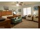 Spacious bedroom with seating, a bed, a ceiling fan, and a nautical theme at 1844 E Angelica St, Casa Grande, AZ 85122