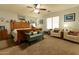 Spacious bedroom with seating, a bed, a ceiling fan, and a nautical theme at 1844 E Angelica St, Casa Grande, AZ 85122