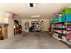 Well-organized garage providing ample storage solutions with shelves, boxes, and overhead door at 1844 E Angelica St, Casa Grande, AZ 85122
