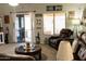 Cozy living room featuring a sliding glass door, nautical decor, comfortable seating, and a round coffee table at 1844 E Angelica St, Casa Grande, AZ 85122