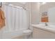 A clean bathroom featuring a shower-tub combo, white vanity, and tiled floors at 18668 N Lariat Ct, Surprise, AZ 85387