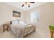Cozy bedroom with neutral walls, a brass bed frame, and plantation shutters at 18668 N Lariat Ct, Surprise, AZ 85387