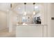 Bright kitchen with granite countertops, stainless steel appliances, and a breakfast bar overlooking the dining area at 18668 N Lariat Ct, Surprise, AZ 85387