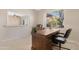 A home office featuring a traditional wooden desk and a large window view of the backyard at 18668 N Lariat Ct, Surprise, AZ 85387