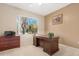 Bright office space with a large window overlooking the landscaped yard, and traditional furniture at 18668 N Lariat Ct, Surprise, AZ 85387