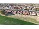 An aerial view captures a neatly planned community with uniform terracotta roofs, bordering a lush green space at 1960 Leisure World --, Mesa, AZ 85206