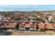 A lovely aerial view showcases the terracotta-roofed homes of a well-maintained neighborhood against a mountain backdrop at 1960 Leisure World --, Mesa, AZ 85206