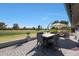 Charming back patio offers comfortable seating, a fire table, and scenic golf course views at 1960 Leisure World --, Mesa, AZ 85206