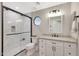 Modern bathroom featuring a granite countertop, black fixtures, and a walk-in shower with a glass enclosure at 1960 Leisure World --, Mesa, AZ 85206