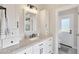 Bright bathroom featuring granite countertops, modern fixtures, and a well-lit vanity with ample storage space at 1960 Leisure World --, Mesa, AZ 85206