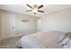 This bedroom has neutral walls and flooring, a modern ceiling fan, and minimalist decor at 1960 Leisure World --, Mesa, AZ 85206