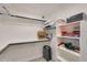 Organized walk-in closet with shelving for shoes, accessories, and stacked puzzles at 1960 Leisure World --, Mesa, AZ 85206