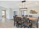 Elegant dining room with a large wooden table, modern lighting fixture, and hardwood floors at 1960 Leisure World --, Mesa, AZ 85206