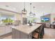 Open-concept kitchen with granite countertops and eat-in island, stainless appliances, and seamless flow to the living area at 1960 Leisure World --, Mesa, AZ 85206