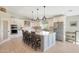 Bright, updated kitchen featuring a large center island with barstool seating, stainless appliances, and modern finishes at 1960 Leisure World --, Mesa, AZ 85206