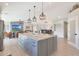 Open-concept layout featuring a gourmet kitchen with an oversized island and a view into the living area at 1960 Leisure World --, Mesa, AZ 85206