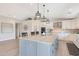 Spacious open-concept kitchen with a large island, stylish pendant lighting, and modern appliances at 1960 Leisure World --, Mesa, AZ 85206