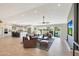 Open-concept living room with sleek hardwood floors connects to a bright kitchen and features backyard views at 1960 Leisure World --, Mesa, AZ 85206