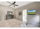 Comfortable main bedroom with ensuite bathroom featuring neutral tones and a ceiling fan at 1960 Leisure World --, Mesa, AZ 85206