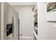 Pantry with stainless steel refrigerator and open shelving at 1960 Leisure World --, Mesa, AZ 85206