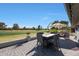 Inviting outdoor patio with a fire pit table and golf course views, perfect for relaxation and entertaining at 1960 Leisure World --, Mesa, AZ 85206