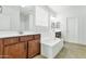 A bathroom featuring double sinks, a bathtub, a window, and wood cabinets at 2146 W Ian Dr, Phoenix, AZ 85041