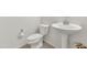 Cozy bathroom features a white toilet, sink, and clean, minimalist design at 2146 W Ian Dr, Phoenix, AZ 85041