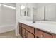 Bathroom featuring white countertops, wood cabinets, and a shower at 2146 W Ian Dr, Phoenix, AZ 85041