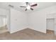 A bedroom featuring an open closet, white walls, and a ceiling fan at 2146 W Ian Dr, Phoenix, AZ 85041