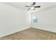A clean bedroom featuring a ceiling fan, carpeted floor, and natural light at 2146 W Ian Dr, Phoenix, AZ 85041