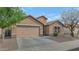 Charming single-story home with a well-maintained yard, a two-car garage, and desert landscaping at 2146 W Ian Dr, Phoenix, AZ 85041