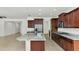 Spacious kitchen features an island, granite counters, stainless appliances, and dark wood cabinetry at 2146 W Ian Dr, Phoenix, AZ 85041