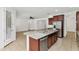 Granite kitchen island with stainless steel dishwasher and sink near a stainless refrigerator at 2146 W Ian Dr, Phoenix, AZ 85041