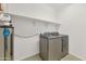 A laundry room featuring a shelf, a water filtration system, and a washer/dryer at 2146 W Ian Dr, Phoenix, AZ 85041