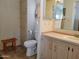 Bathroom features a toilet, vanity, mirror, and built-in linen closet at 2460 E Main St # A2, Mesa, AZ 85213