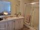 Bathroom featuring a vanity with mirror, shower, and neutral color palette at 2460 E Main St # A2, Mesa, AZ 85213