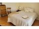Cozy bedroom features a comfortable bed, antique desk and a chair at 2460 E Main St # A2, Mesa, AZ 85213