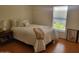 Bright bedroom with laminate flooring, a comfortable bed, and a cozy atmosphere at 2460 E Main St # A2, Mesa, AZ 85213