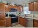 Well-equipped kitchen with stainless steel appliances, wooden cabinets, and modern fixtures at 2460 E Main St # A2, Mesa, AZ 85213