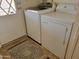 Laundry room includes washer, dryer, door, and tile flooring at 2460 E Main St # A2, Mesa, AZ 85213