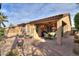Spacious backyard with covered patio and desert landscaping perfect for enjoying the outdoors at 2611 E San Simeon Dr, Casa Grande, AZ 85194