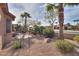 View of the backyard with desert landscaping including gravel, rocks, and desert trees at 2611 E San Simeon Dr, Casa Grande, AZ 85194